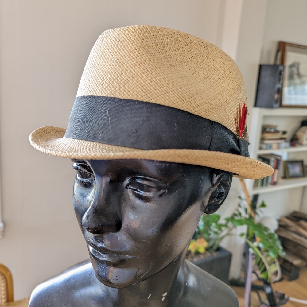 Tan fedora made in Ecuador with black beans and feathers